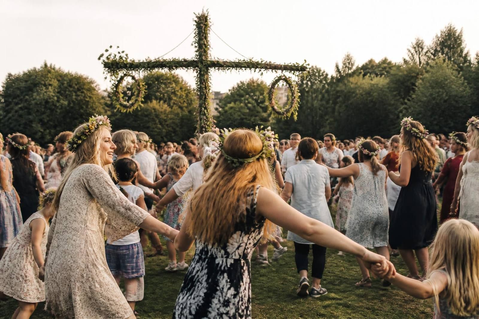 Swedish community in London dancing around the midsummer pole at golden hour