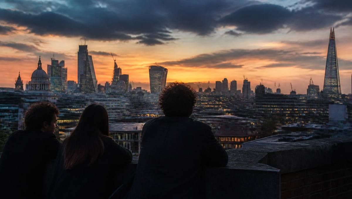 Friends looking out over the London skyline at dusk